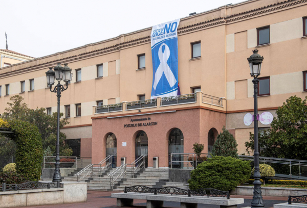 Fachada del ayuntamiento con cartel en contra de la violencia de género